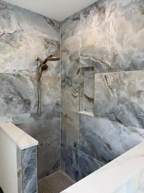 Large-format blue gray tile shower installed by Braga Remodeling