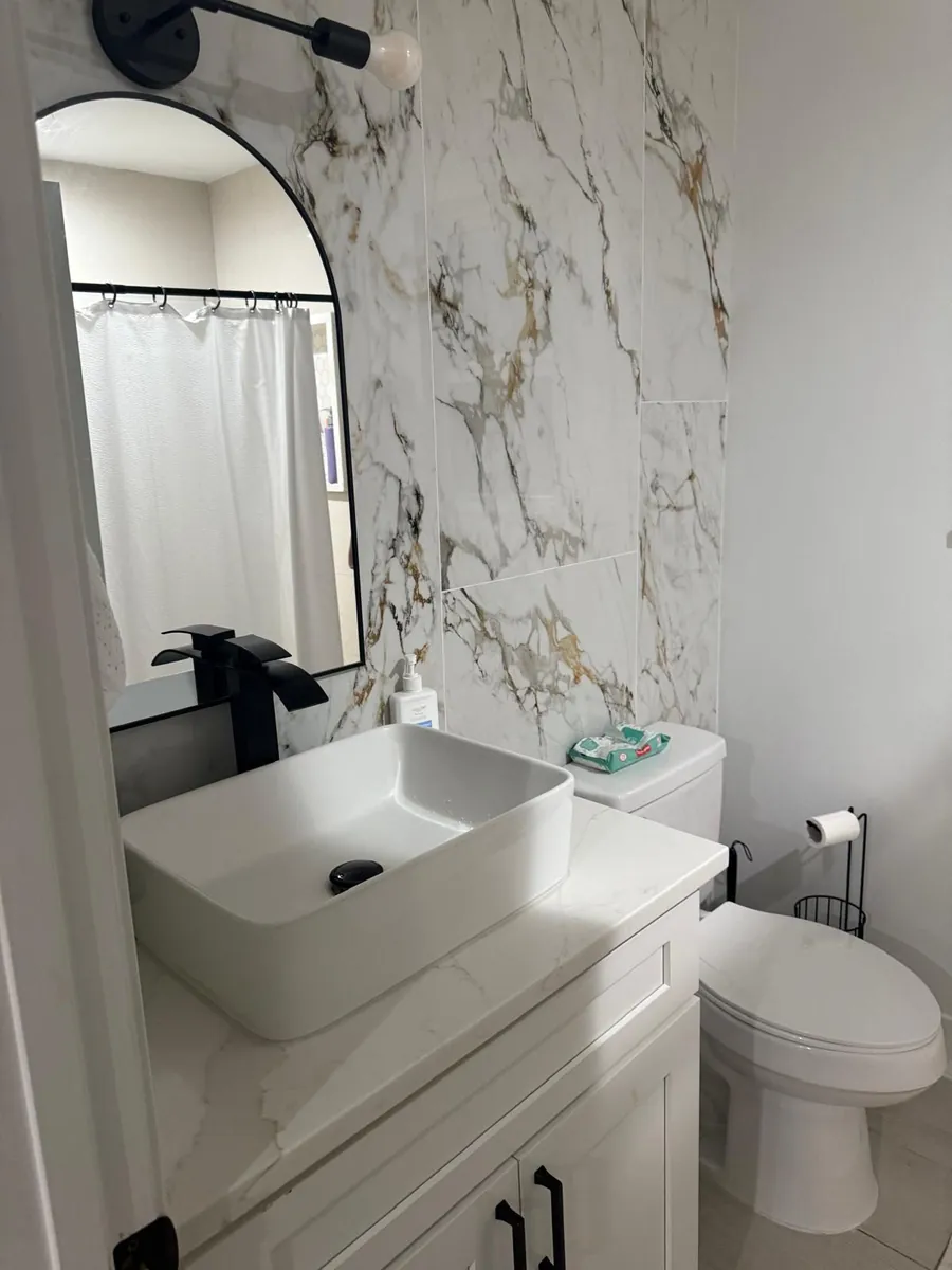 Bathroom vanity and tile work completed by Braga Remodeling