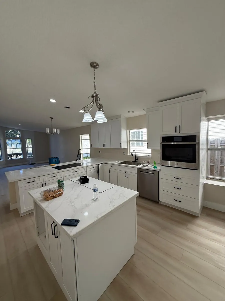 Kitchen with vinyl plank flooring coordinated with the cabinetry by Braga Remodeling
